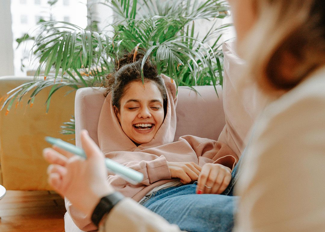 psychiatrist meeting with a young girl who is laughing