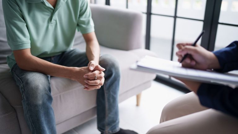 person sitting across from a therapist talking